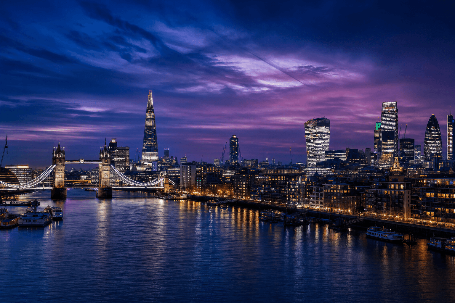 London city skyline at night with blue and purple tones, River Thames and Tower Bridge
